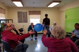 Bay Aging Adult Day Care Center members hitting balloon