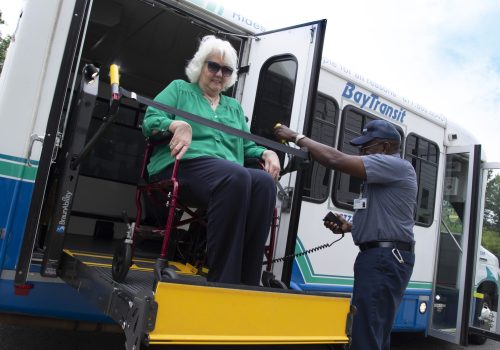 Woman in Wheel Chair On Bus Lift