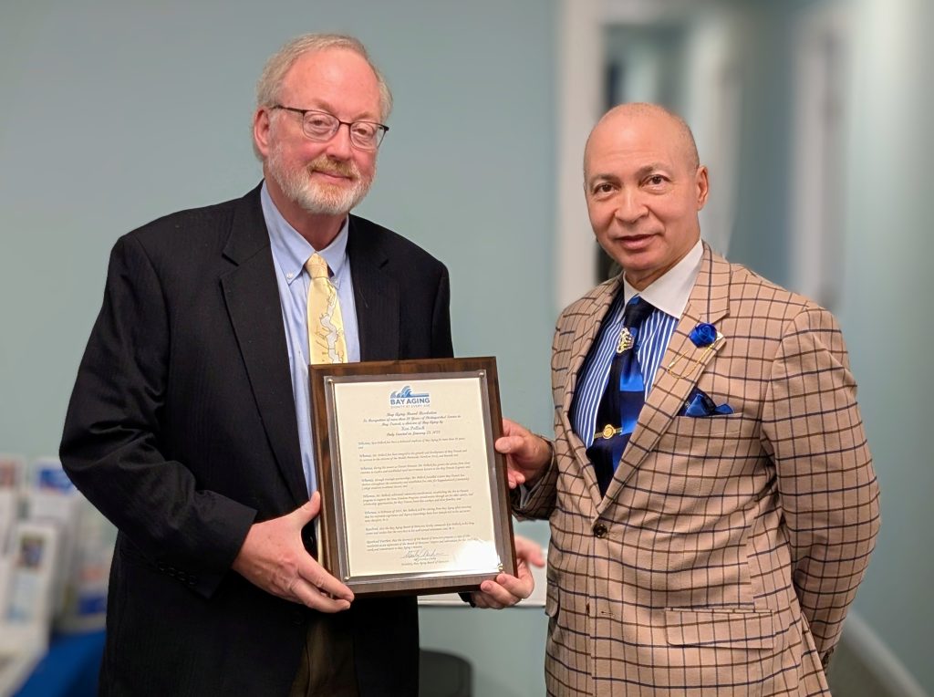 Two men holding award