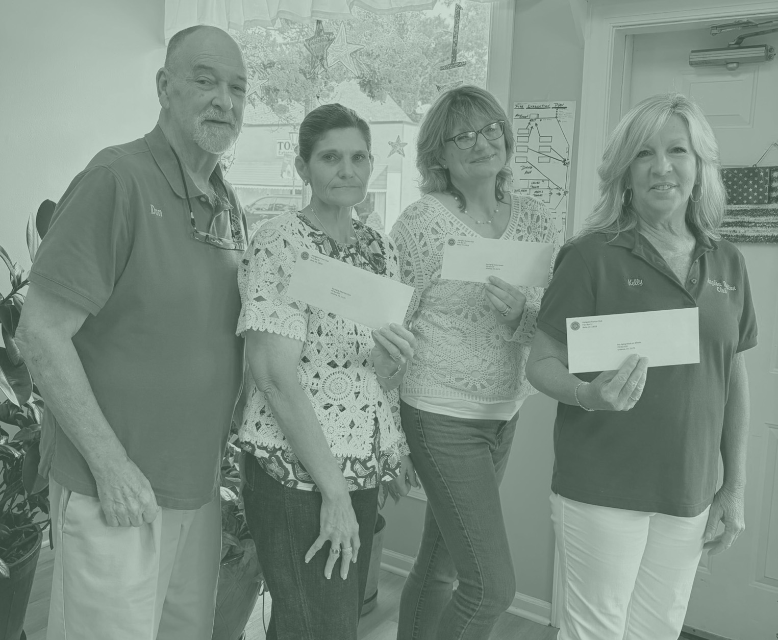 Four people posing for donation picture