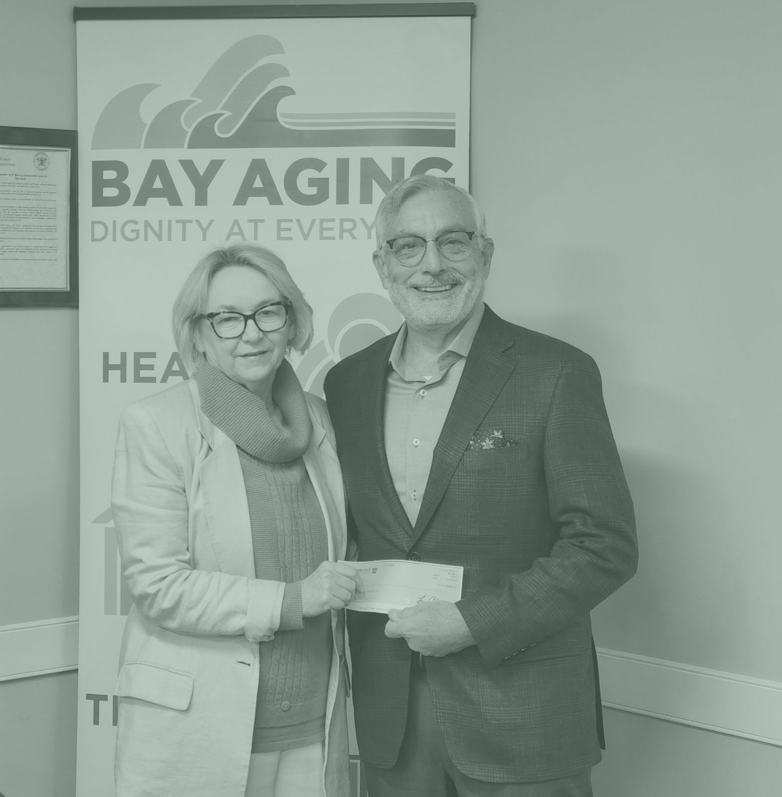 two people holding donation check
