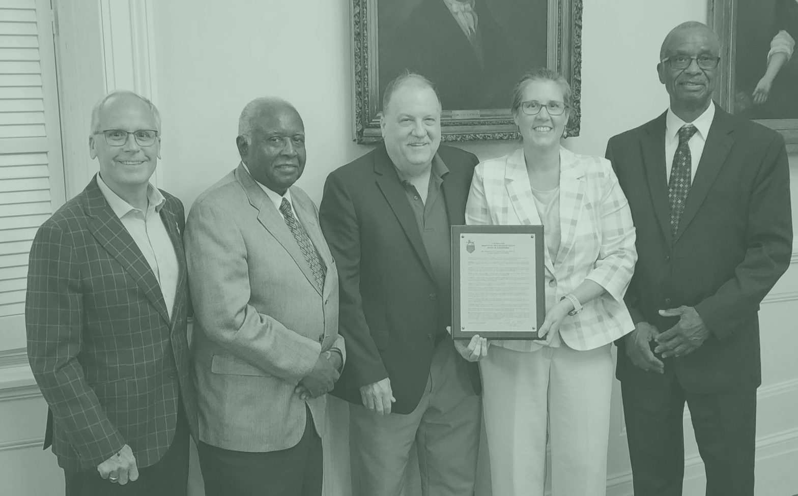 Five people, one holding proclamation