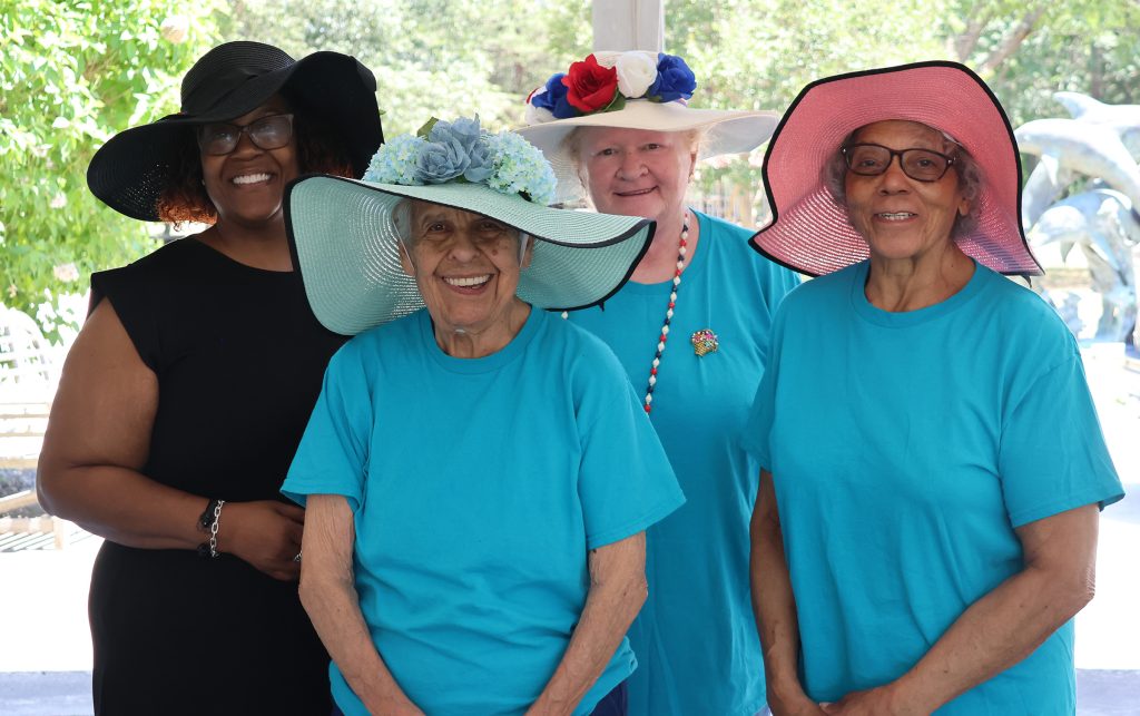 Four women wearing spring hats