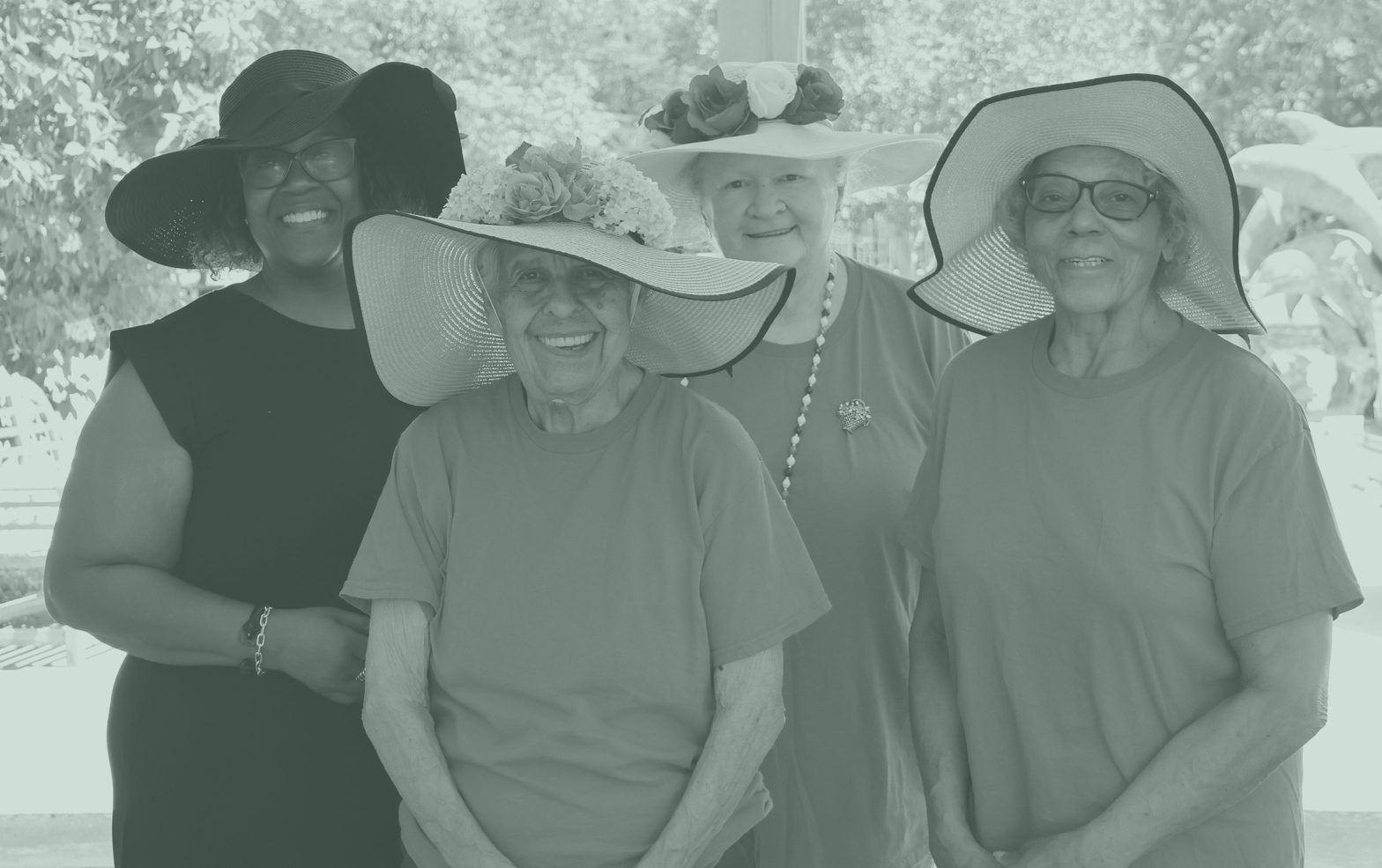 Four women wearing spring hats