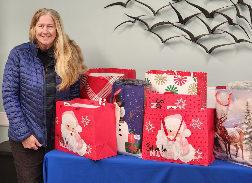 Woman standing by table with gifts