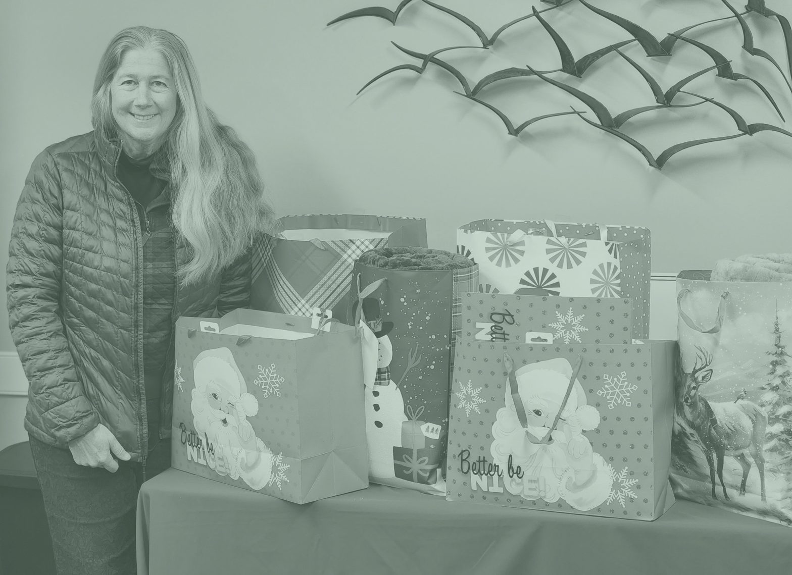 Woman standing by table with gifts