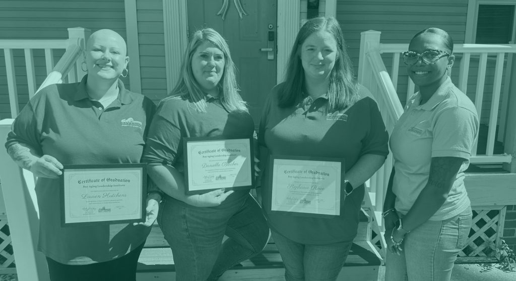 Four woman, three holding certificates