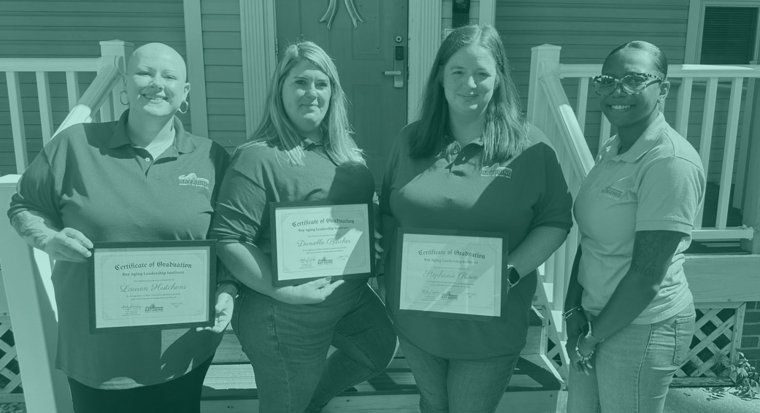 Four woman, three holding certificates